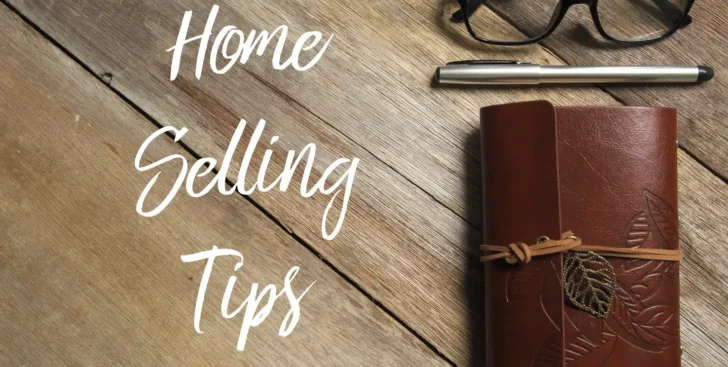 Home selling tips text on a wooden surface with a notebook, pen, and glasses