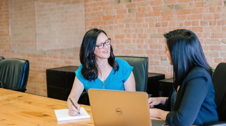 Home seller meeting with a prospective real estate agent at a brokerage office.