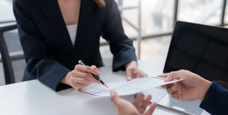 Realtor reviewing a real estate listing agreement with a client