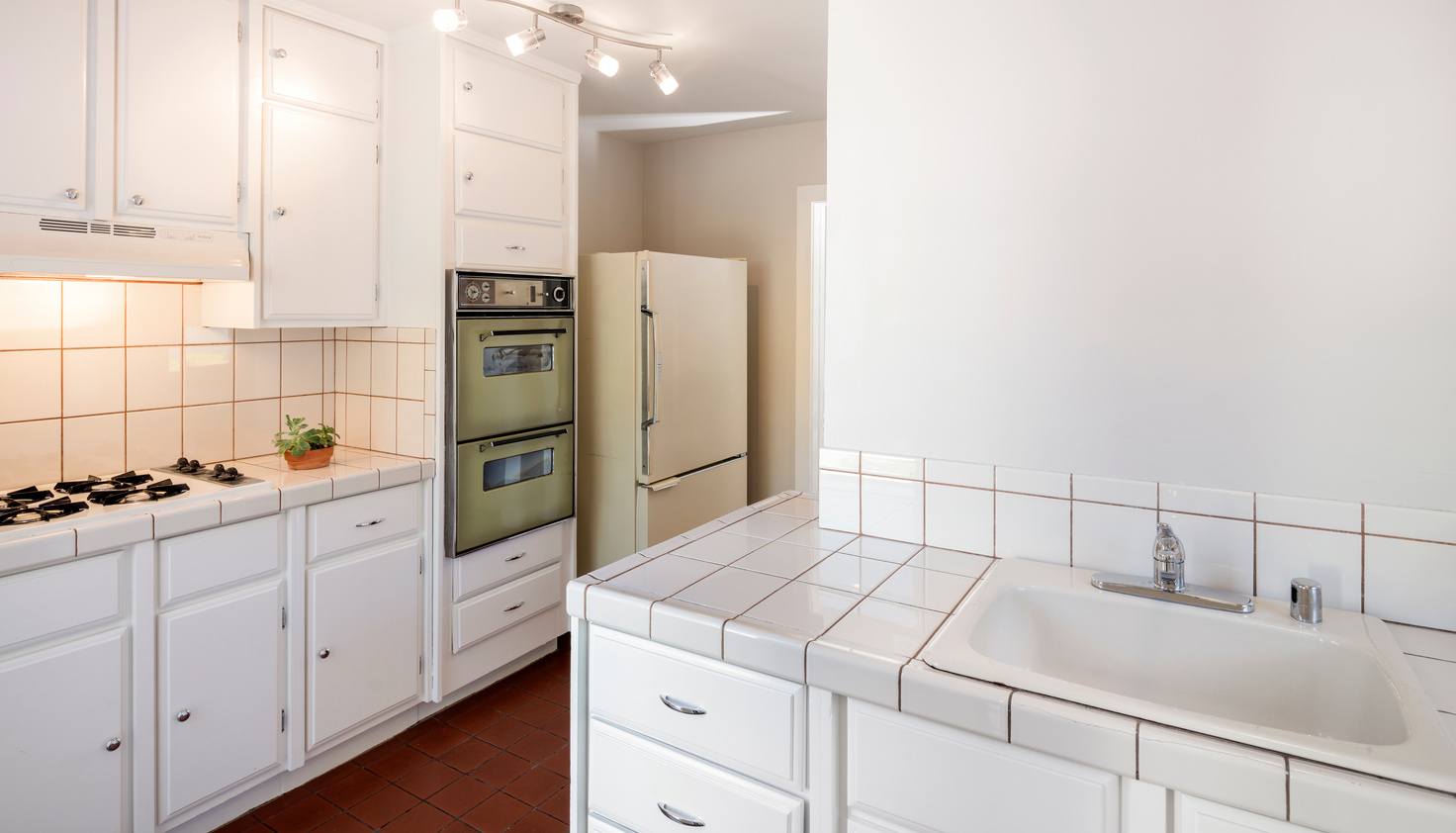 Outdated kitchen in need of repairs and updates, illustrating challenges of selling a house that needs work.