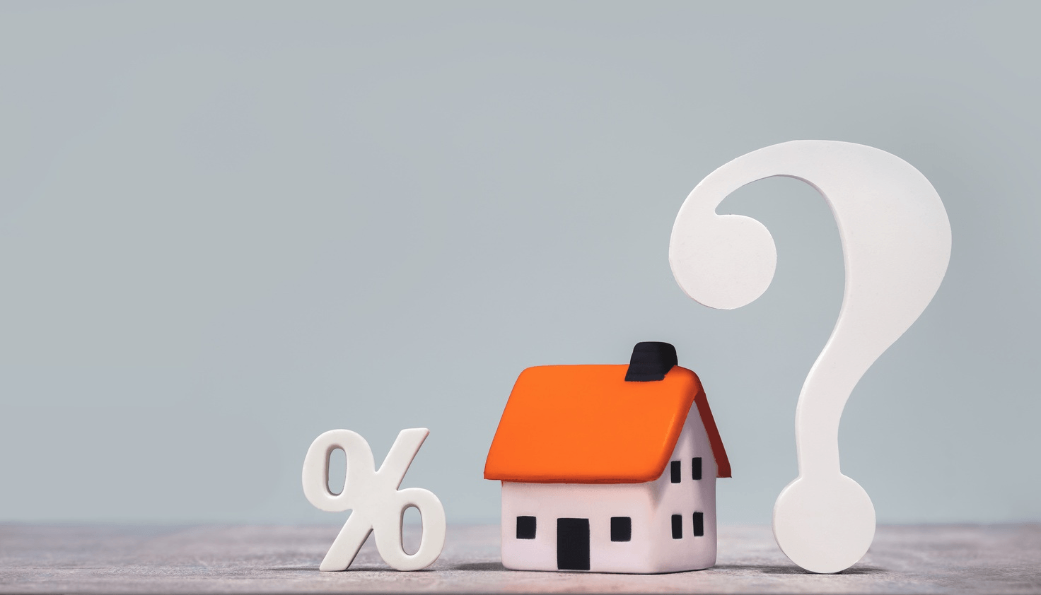 House with percent sign and question mark symbolizing real estate agent commission uncertainty